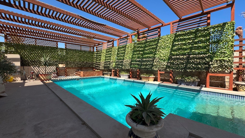 Swimming pool beneath pergola at Wadi Jebal chalet