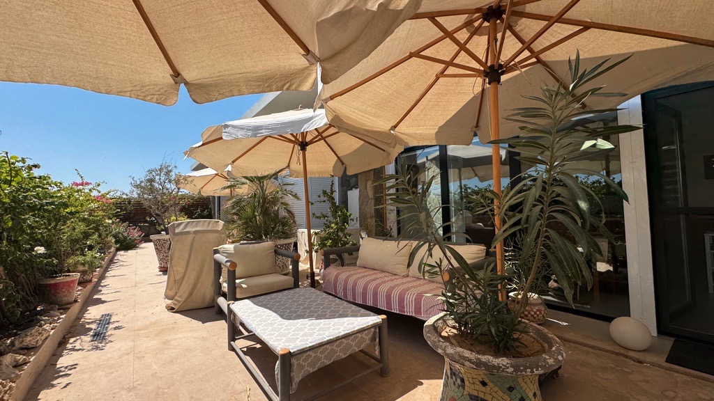 Shaded terrace and seating area at Wadi Jebal chalet